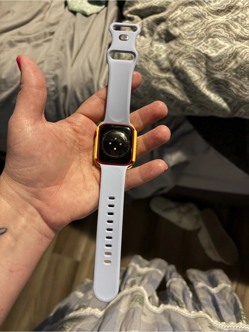 Apple Smartwatch with bag of watch covers and bands and charger.